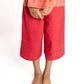 Young girl wearing a red dress with a white background