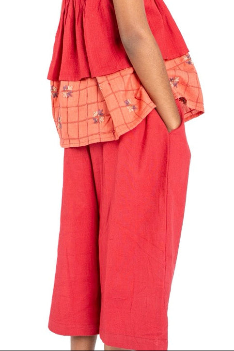 Young girl wearing a red outfit with a white background
