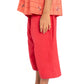 Girl wearing a red outfit with a matching top and pants on a white background
