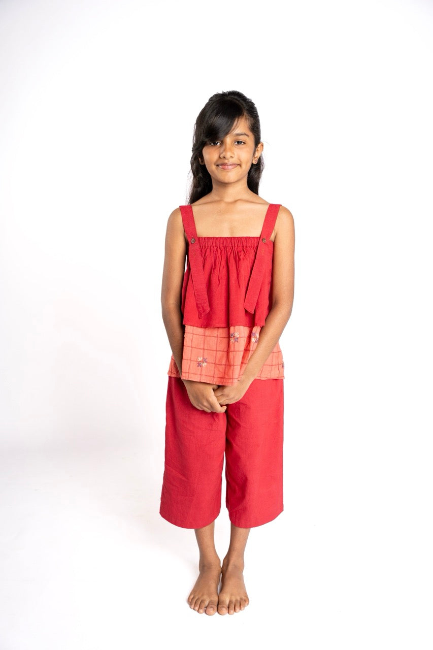 Young girl wearing a red dress with a white background