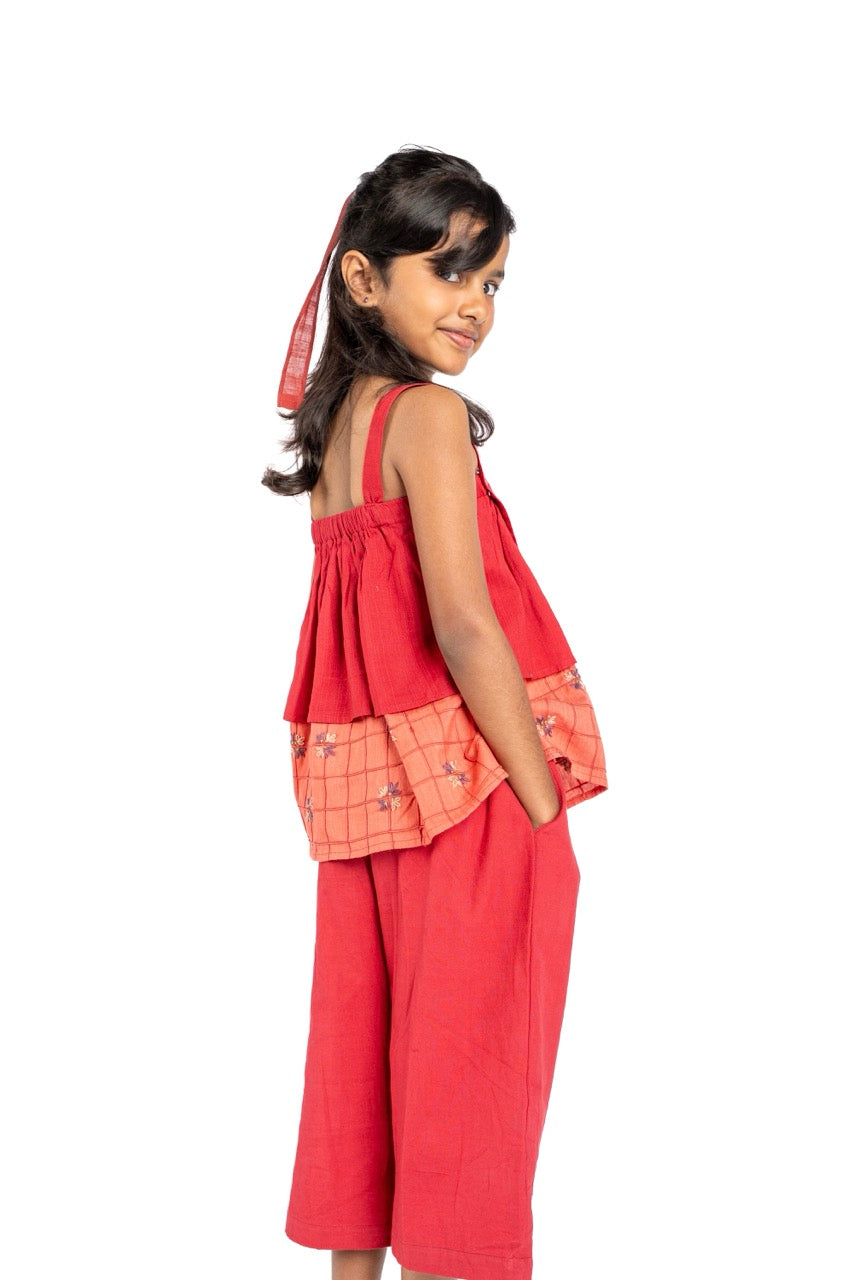 Young girl wearing a red outfit with a white background