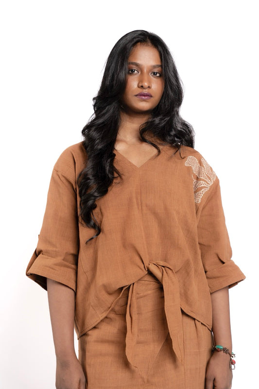 Woman wearing a brown outfit with a white background