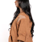 Woman wearing a brown outfit with lace details on a white background