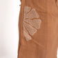 Brown skirt with white floral embroidery on a white background