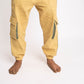 Yellow cargo jogger pants worn by a person on a white background