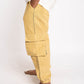 Yellow cargo pants worn by a person on a white background