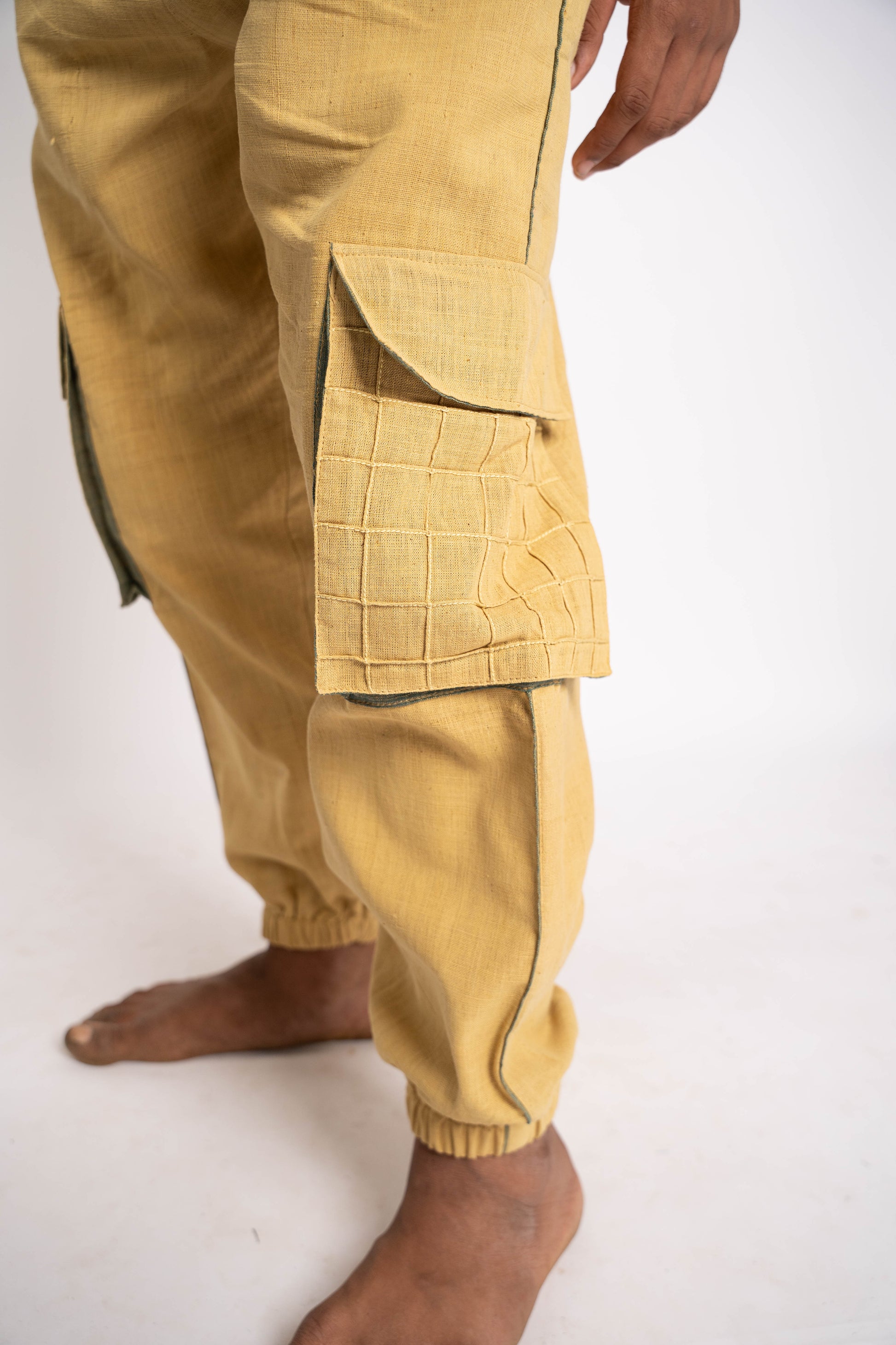 Beige cargo pants on a white background