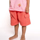 Child wearing a pink outfit with floral embroidery on a white background