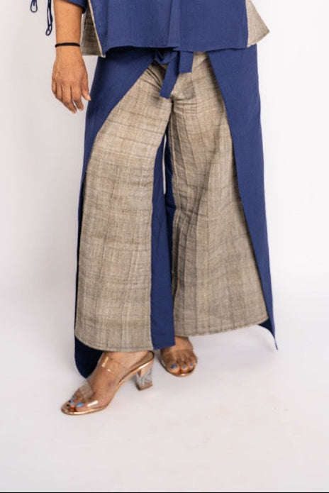 Woman wearing a blue top and plaid pants on a white background