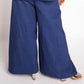 Person wearing a blue outfit with wide-leg pants on a white background
