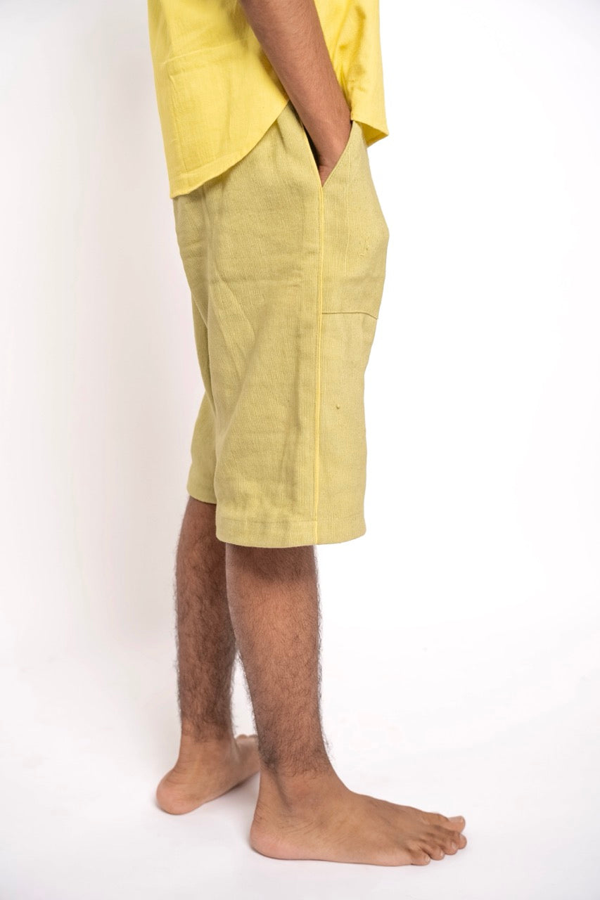 Person wearing yellow shorts on a white background