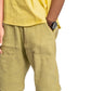 Person wearing a yellow shirt and shorts on a white background