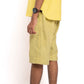 Person wearing yellow shorts and a yellow top on a white background