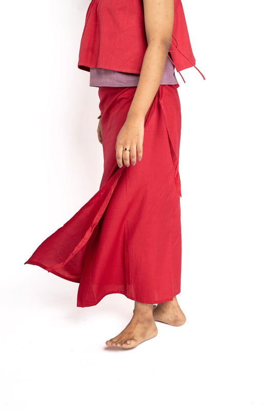 Person wearing a red outfit with a flowing skirt on a white background
