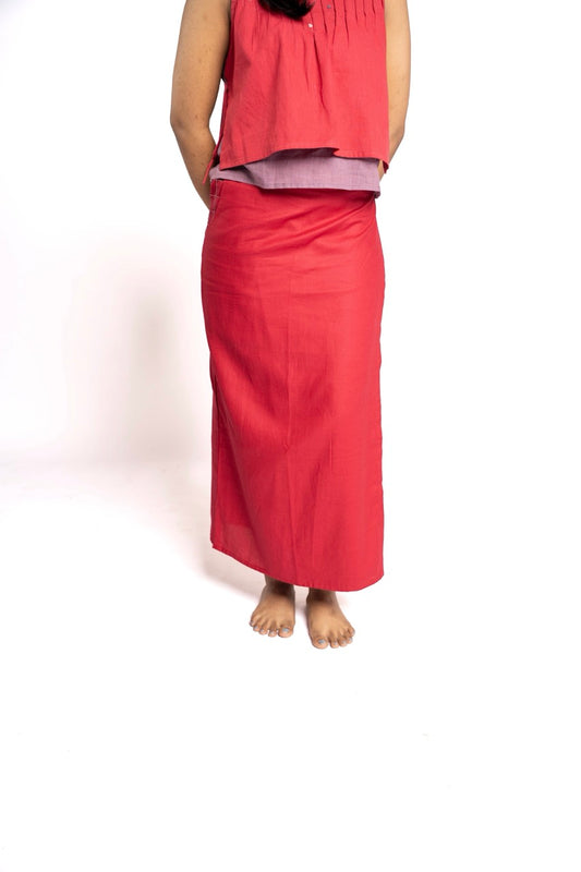 Person wearing a red skirt and top on a white background